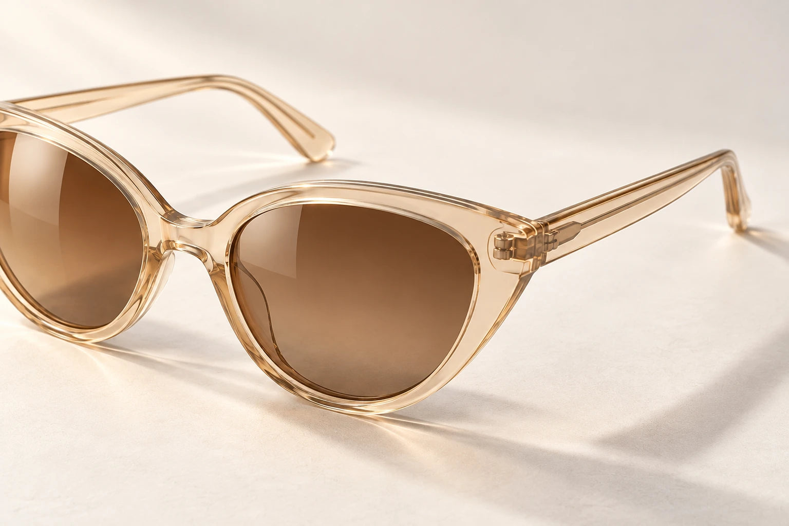 Transparent champagne cat-eye frame and hinge detail
